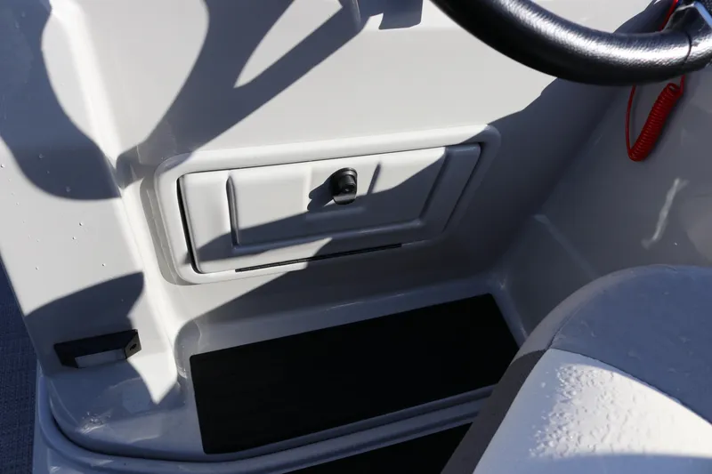 Slide: The Image of 2024 SunChaser Eclipse LR DH 25 Demo boat dashboard with storage compartment. - 20