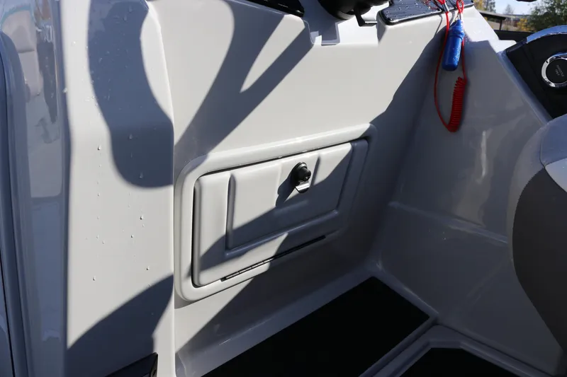 Slide: The Image of 2024 SunChaser Eclipse LR DH 25 Demo boat interior with storage compartment and control panel. - 21