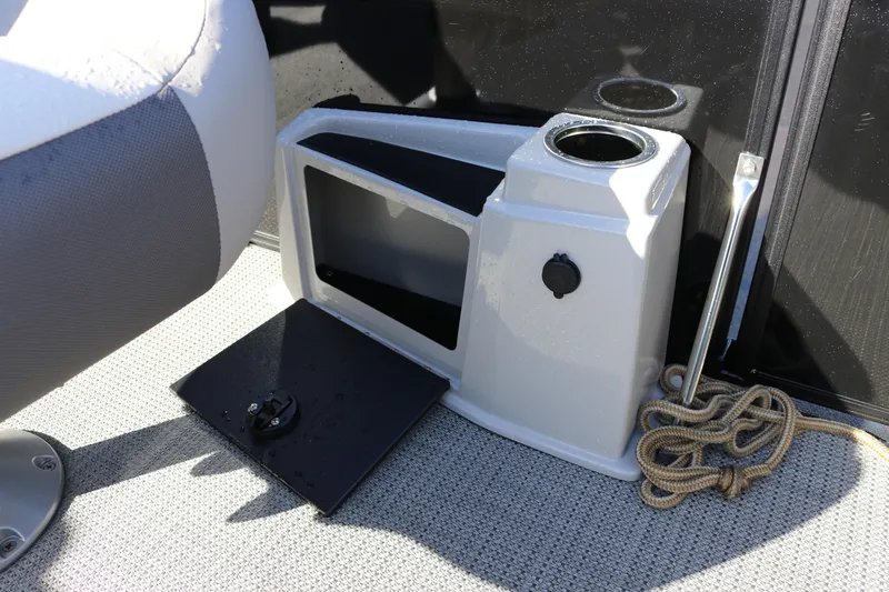 Slide: The Image of 2024 SunChaser Eclipse LR DH 25 Demo boat interior with storage compartment and cup holders. - 25