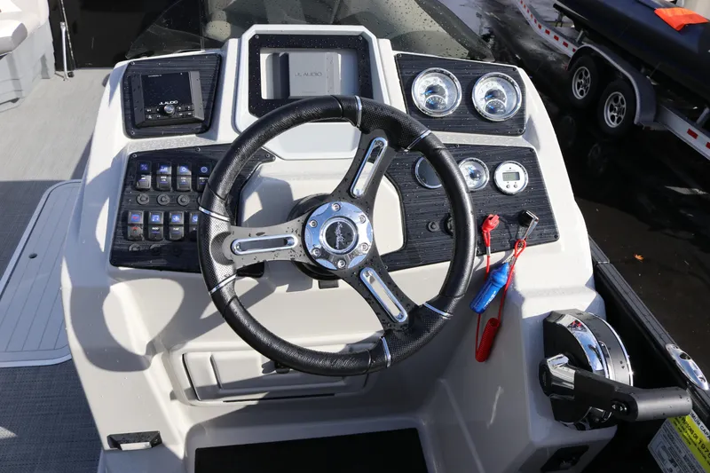 Slide: The Image of 2024 SunChaser Eclipse LR DH 25 Demo boat dashboard with steering wheel and controls. - 8