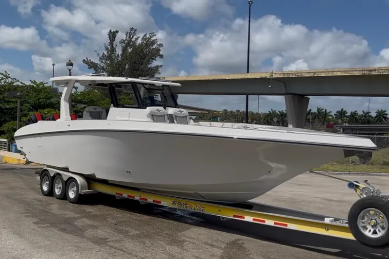 The Image of 2023 Fountain 38 SCX boat on trailer under blue sky. - 0