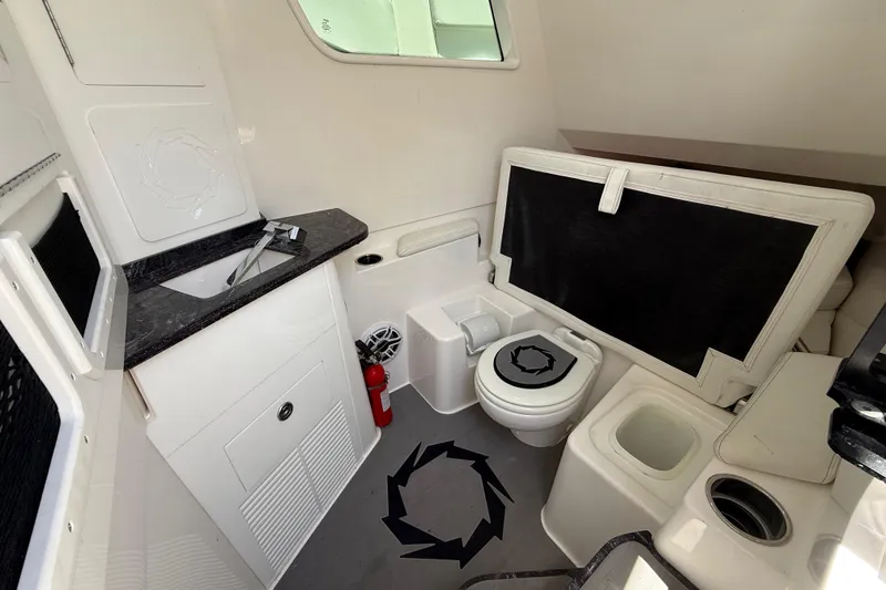 Slide: The Image of Interior of 2023 Fountain 38 SCX boat featuring a compact bathroom setup. - 19