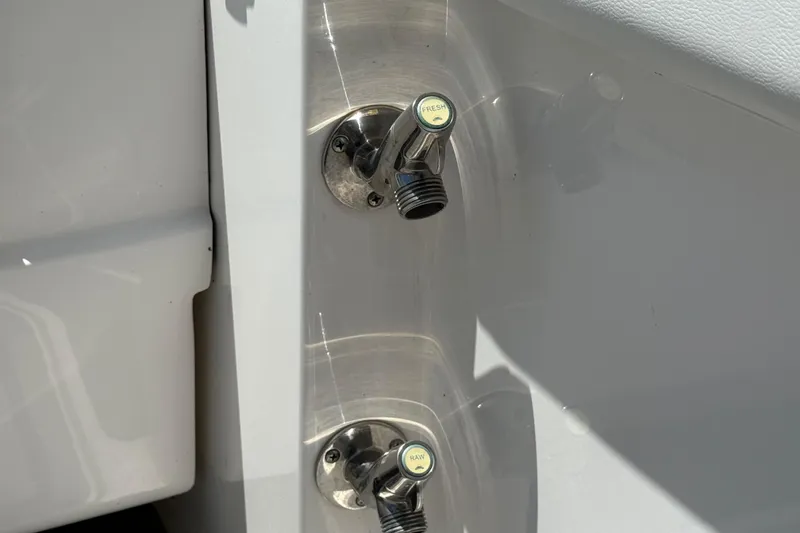 Slide: The Image of 2023 Fountain 38 SCX boat water inlets labeled "Fresh" and "Raw." - 23