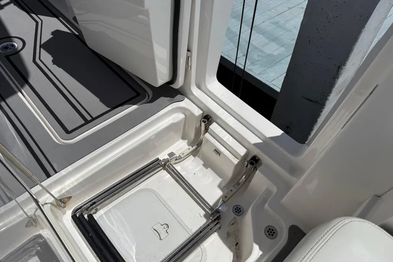 Slide: The Image of 2023 Fountain 38 SCX boat interior showing storage compartment and deck details. - 24