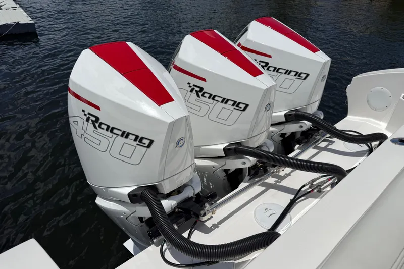 Slide: The Image of Triple Mercury Racing 450 engines on 2023 Fountain 38 SCX boat, docked on water. - 4