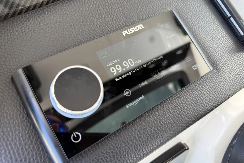 Slide: The Image of Fusion audio system display on 2023 Fountain 38 SCX boat, showing FM station 99.9 MHz. - 9
