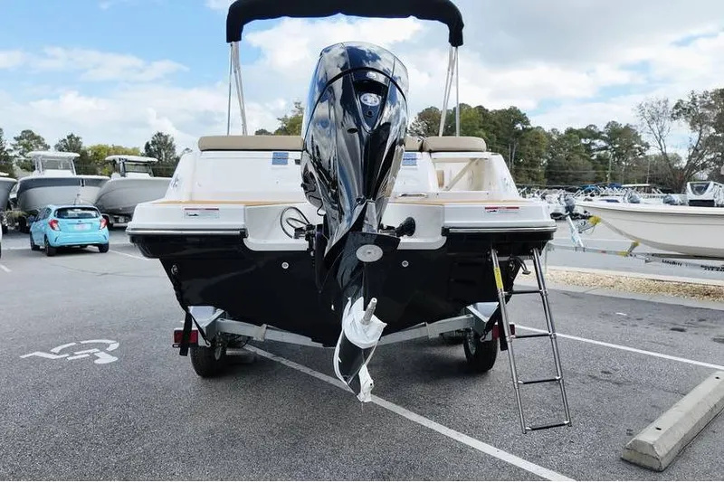 Slide: The Image of 2026 Bayliner VR6 Bowrider OB in parking lot, rear view with outboard motor. - 6