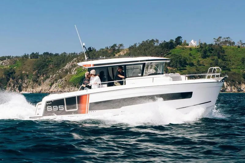 The Image of Manufacturer Provided Image: 2026 Jeanneau NC 895 Sport Series 2 cruising on open water, scenic coastline in background. - 0