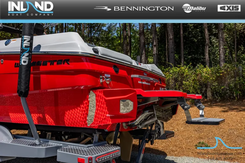 Slide: The Image of Red 2026 Malibu Wakesetter 23 LSV boat parked in forest. - 11