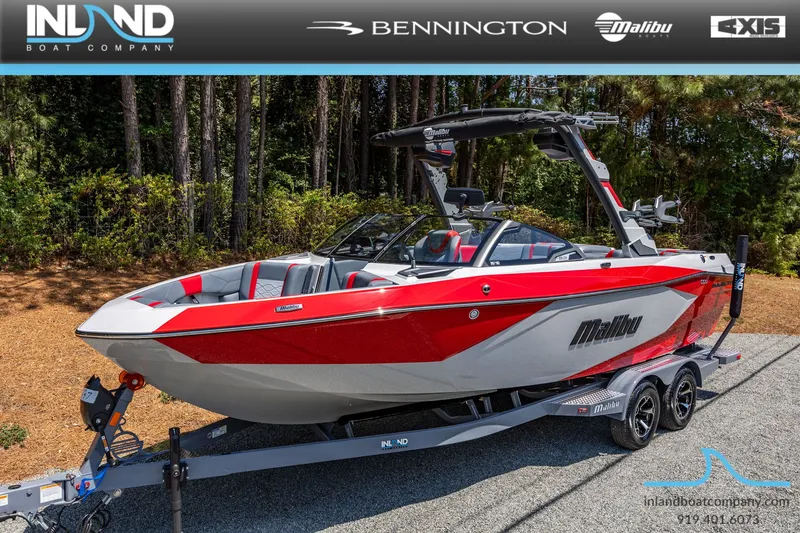 Slide: The Image of 2026 Malibu Wakesetter 23 LSV boat on trailer, red and white design. - 23