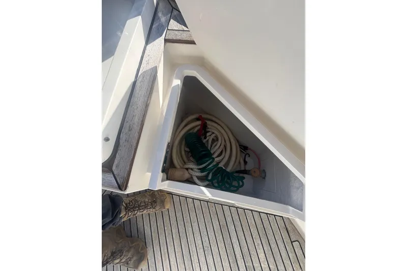 Slide: The Image of Storage compartment on 2006 Grand Banks 47 Heritage EU yacht with coiled ropes and hose. - 10