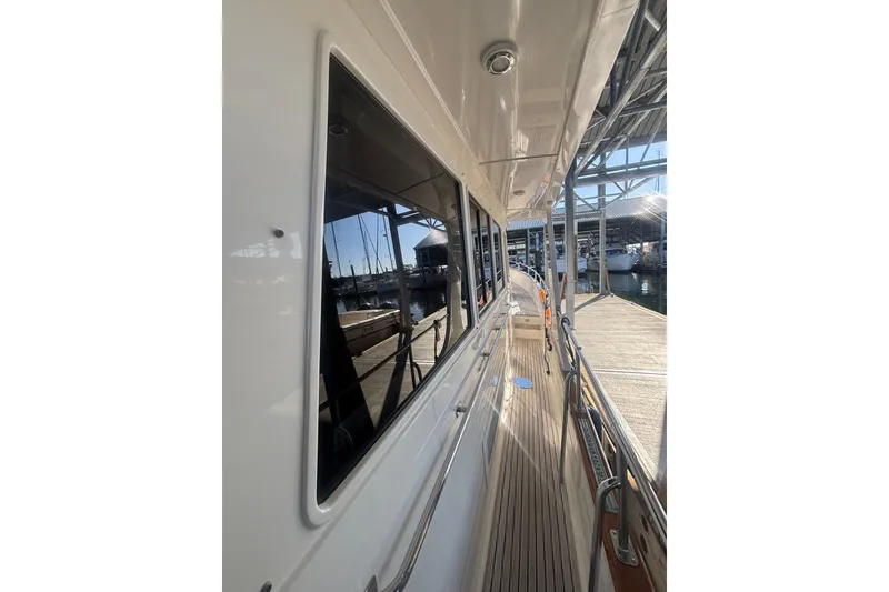 Slide: The Image of Side view of 2006 Grand Banks 47 Heritage EU yacht docked at marina. - 11