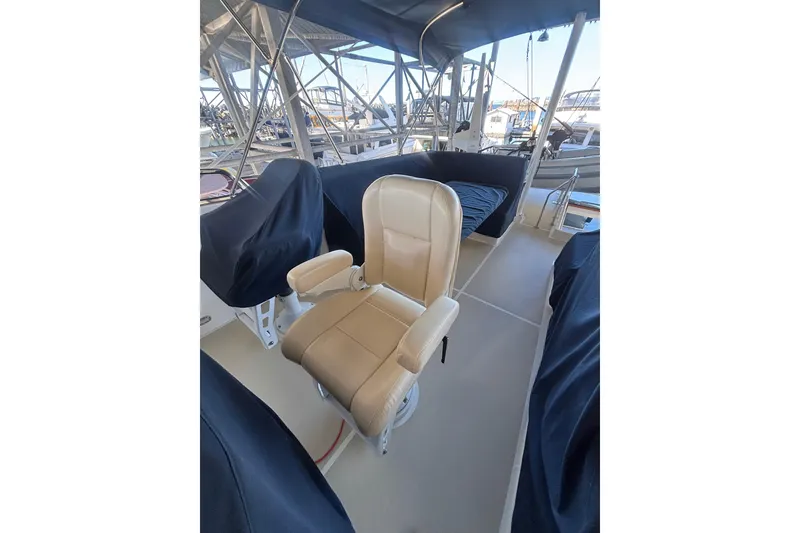 Slide: The Image of Captain's chair on 2006 Grand Banks 47 Heritage EU yacht deck, under canopy. - 14