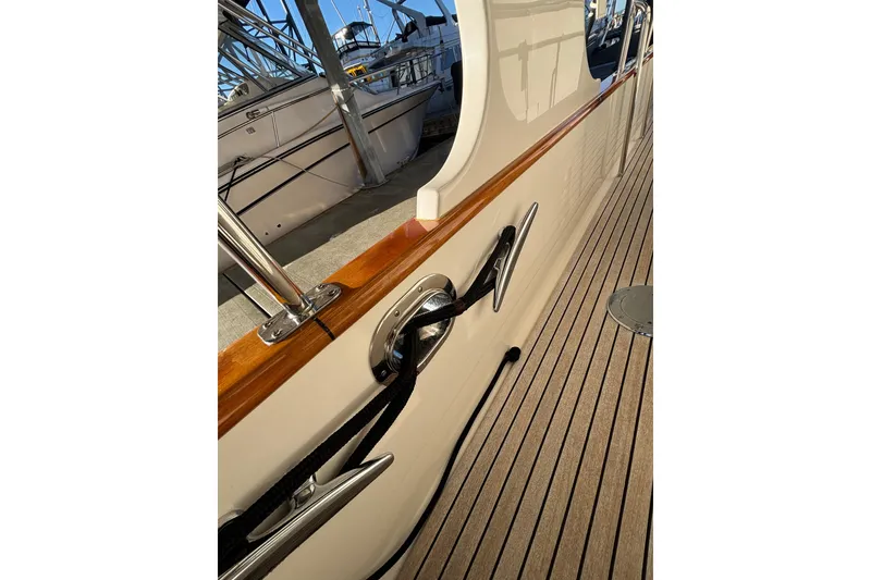 Slide: The Image of 2006 Grand Banks 47 Heritage EU yacht docked with dinghy on top. - 2