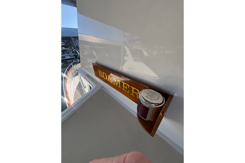 Slide: The Image of 2006 Grand Banks 47 Heritage EU yacht with "ROAMER" sign and marina view. - 23