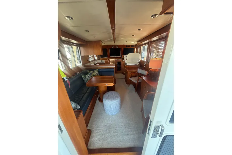 Slide: The Image of Interior of 2006 Grand Banks 47 Heritage EU yacht, featuring elegant wood finishes and cozy seating. - 24
