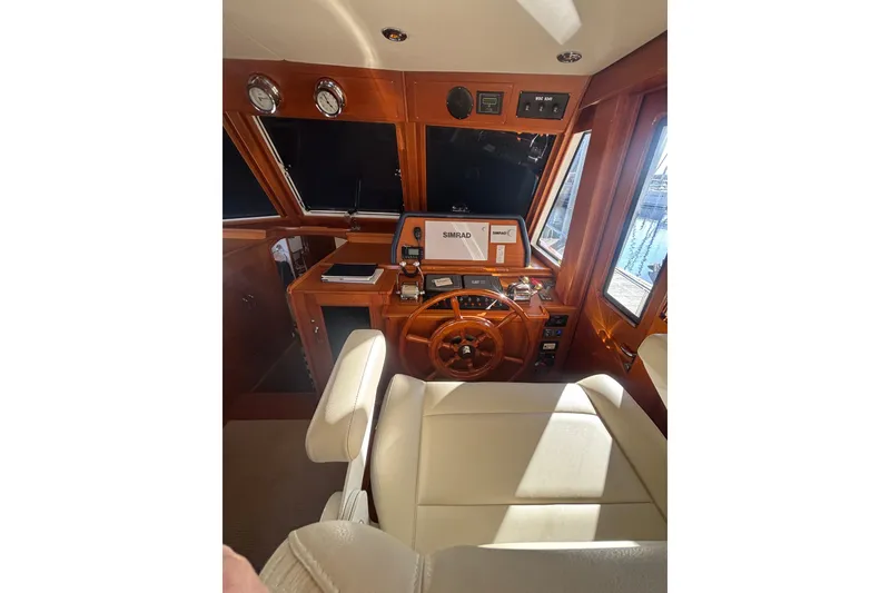 Slide: The Image of Pilothouse of 2006 Grand Banks 47 Heritage EU with wooden helm and navigation equipment. - 27