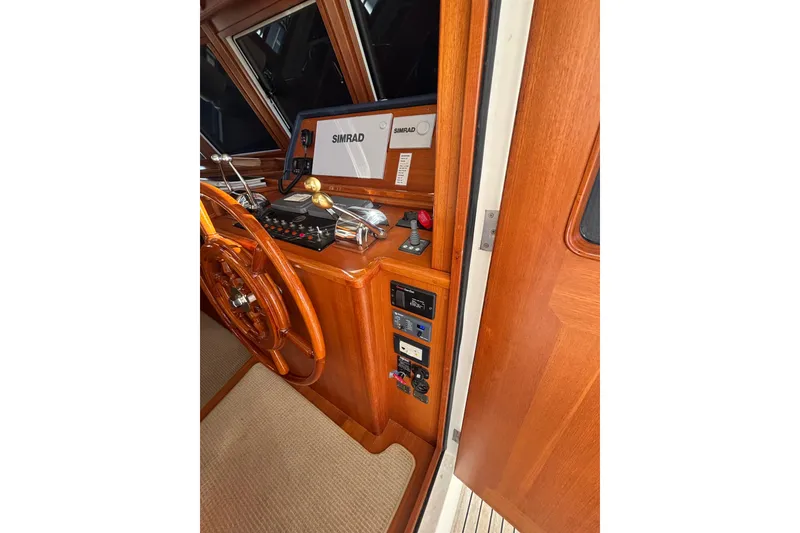 Slide: The Image of 2006 Grand Banks 47 Heritage EU helm with wooden wheel and Simrad navigation system. - 28