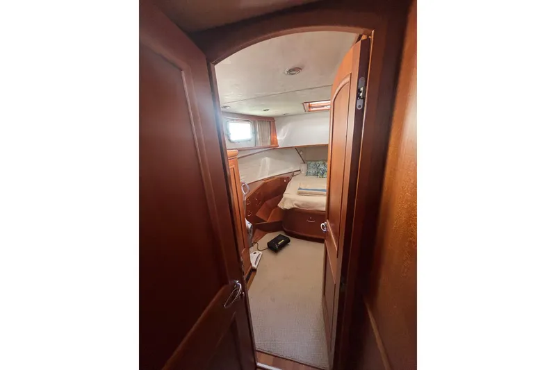 Slide: The Image of Cozy cabin interior of 2006 Grand Banks 47 Heritage EU yacht, featuring wooden finishes and a bed. - 30