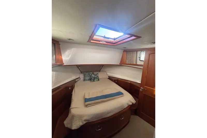 Slide: The Image of Cozy cabin interior of 2006 Grand Banks 47 Heritage EU with skylight and wooden accents. - 31