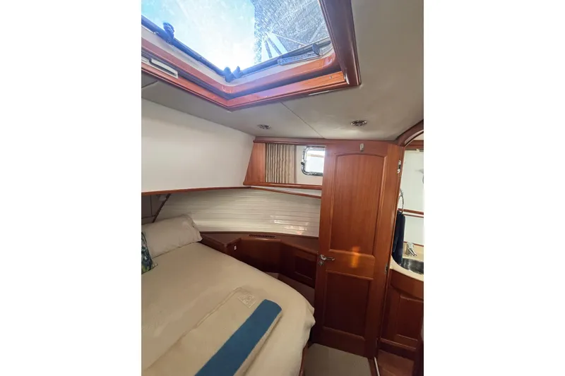 Slide: The Image of Cozy cabin interior of 2006 Grand Banks 47 Heritage EU yacht with skylight and wooden finishes. - 32