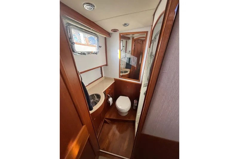 Slide: The Image of Bathroom interior of 2006 Grand Banks 47 Heritage EU yacht, featuring wood accents and compact design. - 33