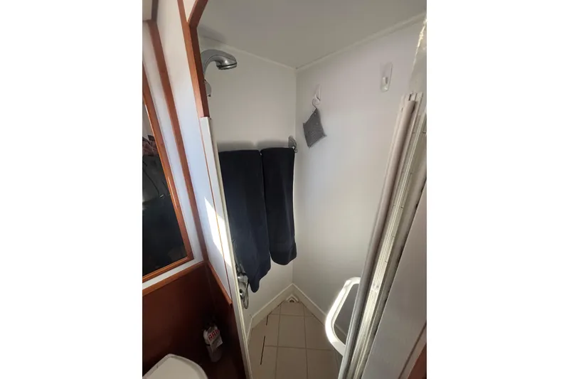 Slide: The Image of Shower area in 2006 Grand Banks 47 Heritage EU yacht, featuring towels and a showerhead. - 34