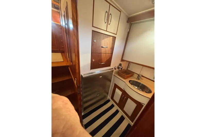 Slide: The Image of 2006 Grand Banks 47 Heritage EU yacht interior with compact sink and storage cabinets. - 36