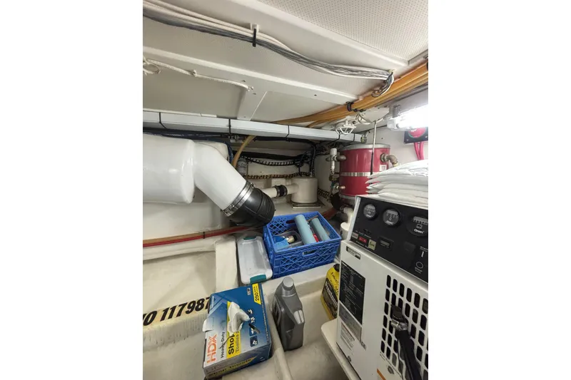 Slide: The Image of Engine room of 2006 Grand Banks 47 Heritage EU with equipment and storage items. - 40