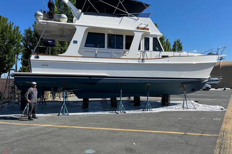 Slide: The Image of 2006 Grand Banks 47 Heritage EU yacht on stands, outdoor setting, clear blue sky. - 47