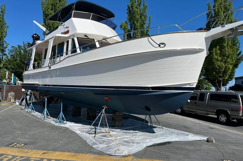 Slide: The Image of 2006 Grand Banks 47 Heritage EU yacht on stands, ready for maintenance under clear blue sky. - 49