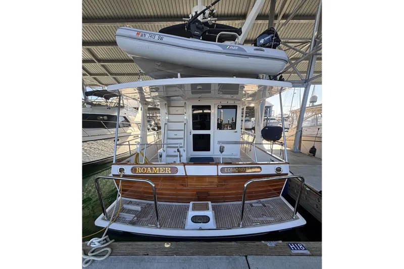 Slide: The Image of 2006 Grand Banks 47 Heritage EU yacht docked with dinghy on top. - 5