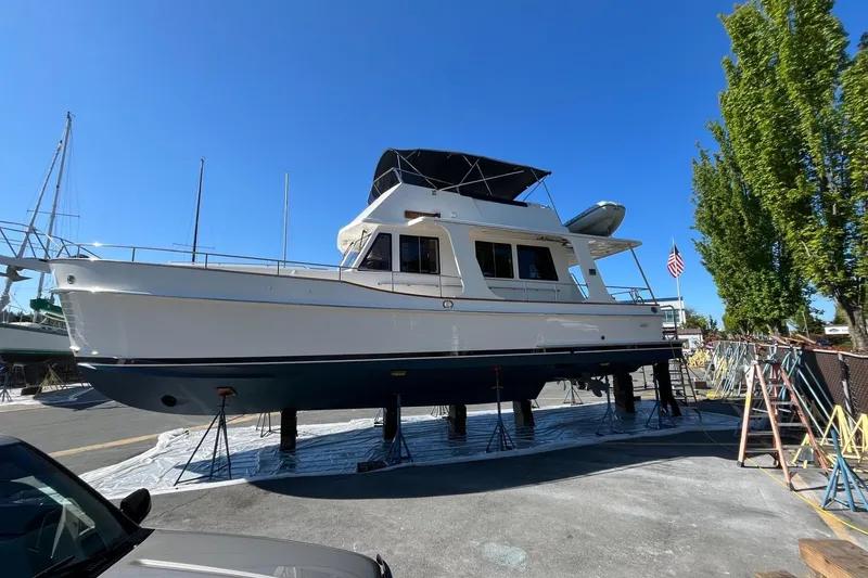 Slide: The Image of 2006 Grand Banks 47 Heritage EU yacht on dry dock under clear blue sky. - 50