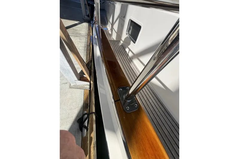 Slide: The Image of 2006 Grand Banks 47 Heritage EU yacht deck with polished wood and stainless steel railing. - 9