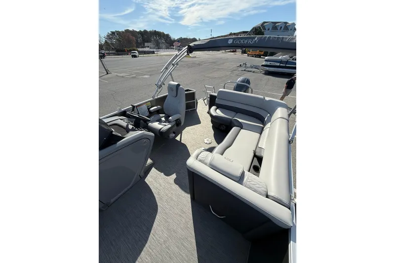 Slide: The Image of 2021 Godfrey Monaco 215 C pontoon boat interior with gray seating and helm. - 10