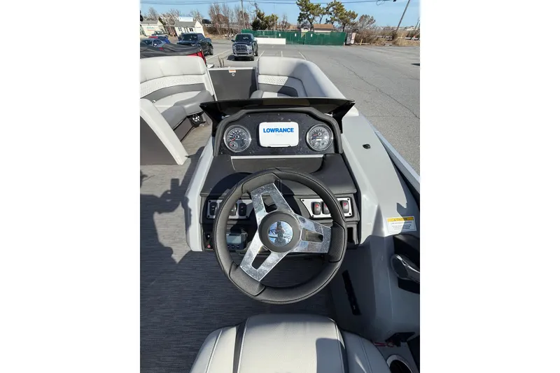 Slide: The Image of Cockpit view of 2021 Godfrey Monaco 215 C boat with steering wheel and Lowrance display. - 14