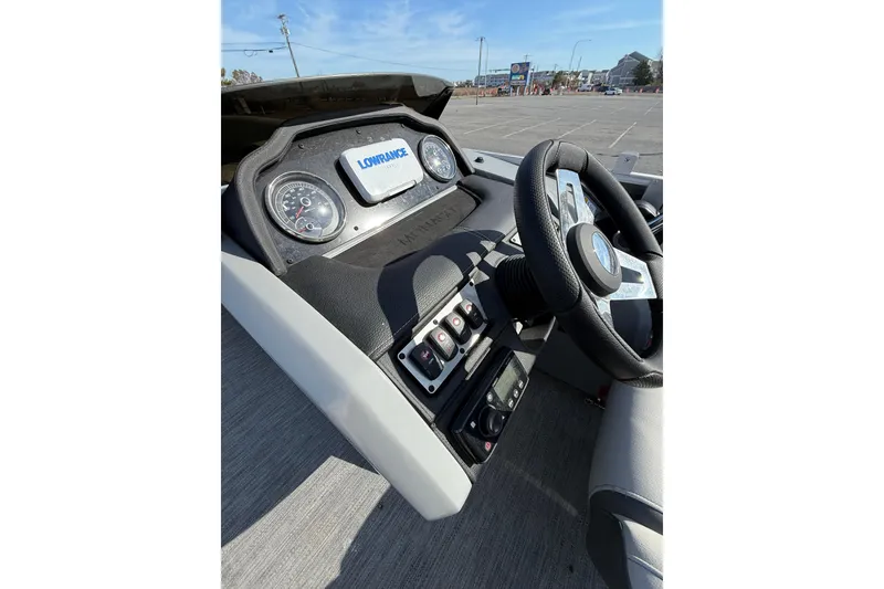 Slide: The Image of 2021 Godfrey Monaco 215 C dashboard with steering wheel and Lowrance display. - 15