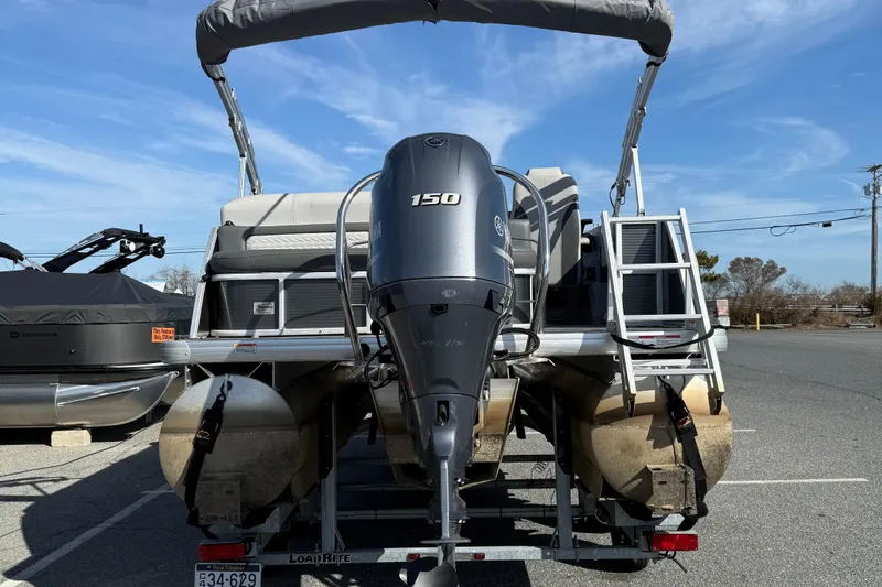 Slide: The Image of 2021 Godfrey Monaco 215 C pontoon boat with Yamaha 150 engine, parked on trailer. - 7