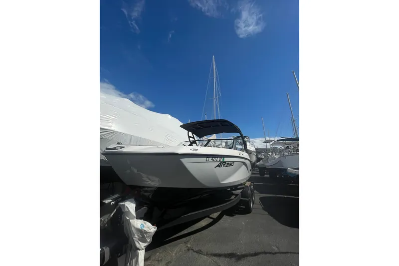 Slide: The Image of 2023 Yamaha Boats AR220 on trailer under clear blue sky. - 10