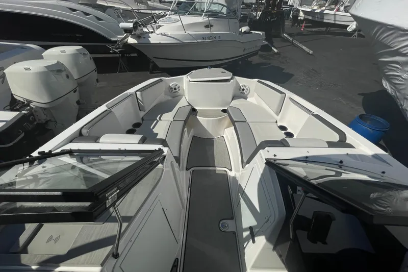 Slide: The Image of 2023 Yamaha Boats AR220 interior view with seating and open windshield. - 13