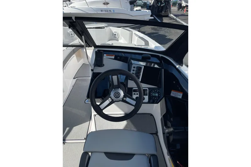 Slide: The Image of 2023 Yamaha Boats AR220 cockpit with steering wheel and control panel. - 6