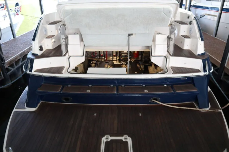 Slide: The Image of 2010 Regal 46 Sport Coupe yacht with open engine compartment, docked in marina. - 13