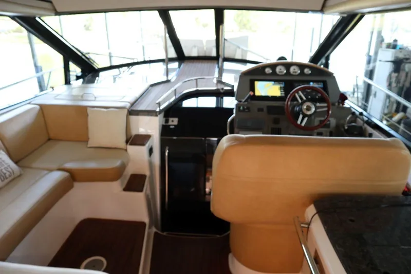 Slide: The Image of Interior of 2010 Regal 46 Sport Coupe yacht with helm and seating area. - 15