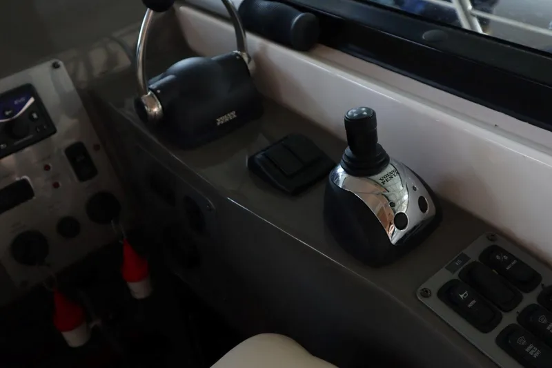 Slide: The Image of Control panel of a 2010 Regal 46 Sport Coupe boat with joystick and throttle. - 16