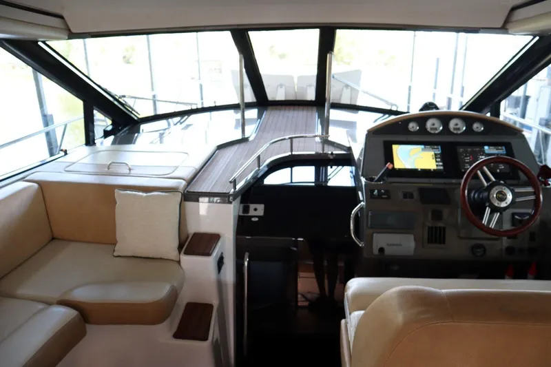Slide: The Image of Interior of 2010 Regal 46 Sport Coupe yacht with helm and seating area. - 17