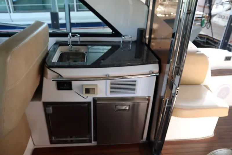 Slide: The Image of Interior of 2010 Regal 46 Sport Coupe yacht with kitchenette and seating area. - 18