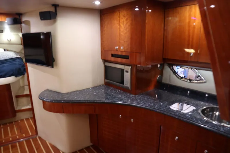 Slide: The Image of Luxurious interior of 2010 Regal 46 Sport Coupe yacht with modern kitchen amenities. - 22