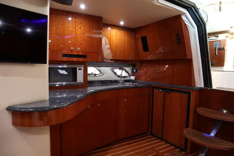 Slide: The Image of Luxurious kitchen interior of 2010 Regal 46 Sport Coupe yacht with wooden cabinetry. - 23