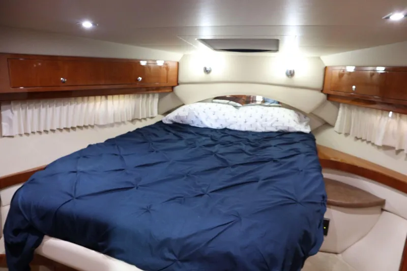 Slide: The Image of Luxurious cabin interior of 2010 Regal 46 Sport Coupe with cozy bed and wooden accents. - 29