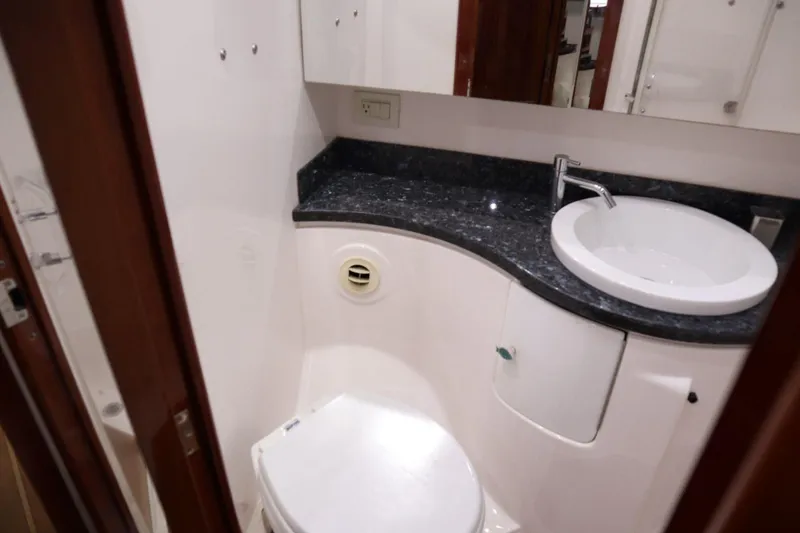 Slide: The Image of Bathroom interior of 2010 Regal 46 Sport Coupe yacht with sink and toilet. - 30